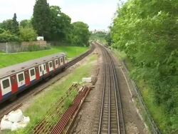 Wimbledon Park Tube Exteriors & Tube Train News Clip