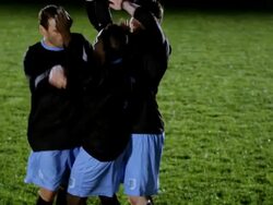 SLO MO TU professional soccer player being lifted on to shoulders of teammates in celebration on field Stock Footage
