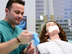 DOLLY: Young woman in dentist office Stock Footage