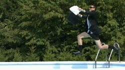 HD Super Slow-Mo: Cheerful Yuppie Jumping Into The Pool Stock Footage