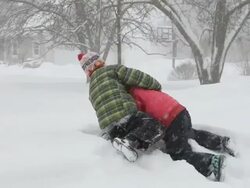 WS PAN ZI Boy and girl playing rugby during snowstorm / Yarmouth, Maine, USA Stock Footage