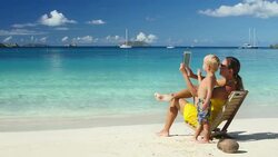 video of family taking a self-portrait photographs at the beach Stock Footage