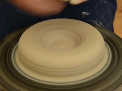 CU Shot of female potter shapes a pot from lump of clay on potterwheel at pottery / Landshut, Bavaria, Germany Stock Footage