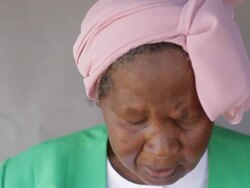 African lady looking down, reading Stock Footage