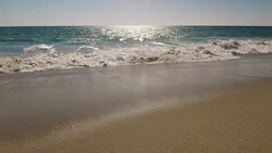 Beach scene showing sand, sea and sky Stock Footage