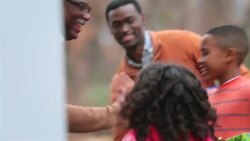 Excited family arrive at grandpa's house for Christmas, welcomed with hugs Stock Footage