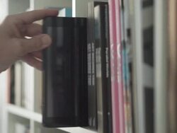 Digital tablet with chromakey in a library bookshelf   ID Stock Footage