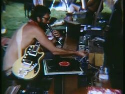 1969 SLO MO MS Musician adjusting audio system at Woodstock music festival/ Bethel, New York, USA Stock Footage