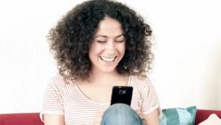 DOLLY: Young woman video chatting at home Stock Footage