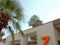 TD establishing exterior view near front door entry of Cody designed 1969 mid-century modern home with frameless window glass Stock Footage