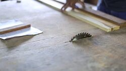 Carpenter at workshop using saw machine on wood work Stock Footage
