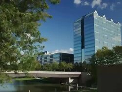 Timelapse of clouds behind a glass office building Gene Leahy Mall Stock Footage