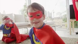 Superhero boy smiling in living room Stock Footage