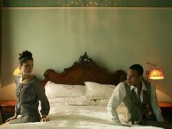 Young couple sitting on bed Stock Footage