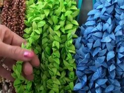 Woman's hands touching some necklaces made with pieces of shells Stock Footage