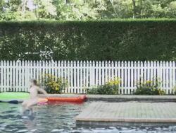 Girl running then jumping into swimming pool in slow motion Stock Footage