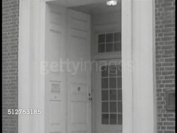 1953: PENNSYLVANIA: LEVITTOWN LOANS: EXT Bristol Trust Company (200 Radciff). DRAMATIZATION: Bank Treasure 'Mr. Moyer' sitting at desk, young adult male entering office, sitting down, Mr. Moyer shaking his hand. Instructional Video