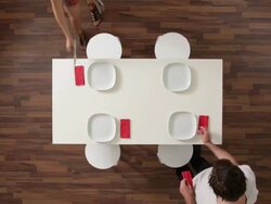 MS, Lockdown, couple setting a dining table, overhead view Stock Footage