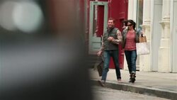 Happy New York couple with shopping bags hurriedly cross Soho street hand-in-hand (dolly-shot) Stock Footage