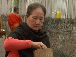 CU Woman giving alms to monks / Luang Prabang, Laos Stock Footage