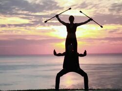 MS Couple poi dancers silhouette perform together with firesticks in front of sunrise and ocean / Montezuma, Costa Rica Stock Footage