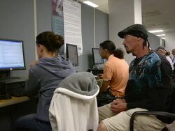 MS Man sitting back side of job seekers working on computers at state run job center / Jackson, Michigan, United States  Stock Footage
