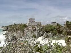 WS View of Pyramid El Castillo (The Castle), Tourists visible around pyramid, on beach and in water / Tulum, Quintana Roo, Mexico Stock Footage