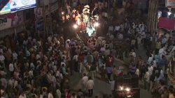 Adults carry symbolic statues through the streets during Diwali. Stock Footage