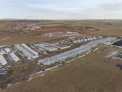 WS AERIAL DS Shot of Bakken oil field temporary worker housing (known locally as "man camp") near Watford City / Watford City, North Dakota, United States Stock Footage