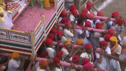 Monks and costumed performers ride a litter carried by men during Diwali. Stock Footage