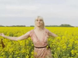 HD SLOW MOTION: Woman Hopping Through Canola Field Stock Footage