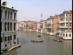 WA high angle view of 3 gondolas on large canal with old Venetian buildings on either side, Venice Stock Footage