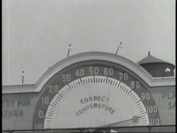 A giant thermometer reads 102 degrees. News Clip