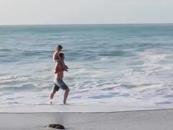 MS PAN Man with boy on his shoulders walking along beach / Montezuma, Puntarenas, Costa Rica Stock Footage
