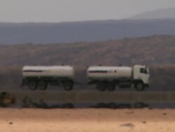 WS PAN Truck tank moving on field / Djibouti Stock Footage