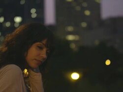 MS TU Shot of beautiful brunette looks out over city bridges at twilight with city behind her / Portland, Oregon, United States  Stock Footage