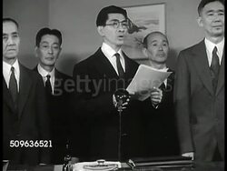 1940: REPRISAL: Japanese male standing behind desk w/ others making speech (being recorded & filmed) saying Japan working in 'harmony w/ Italy & Nazi Germany', the US 'too weak & too pacifistic to interfere' Japan shall have the East Indies. Instructional Video