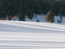 MS Two skiers skiing through snow and giving high five / Gardiner, Montana, United States Stock Footage