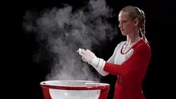 SLO MO Female gymnast clapping wrapped hands over chalk bowl Stock Footage