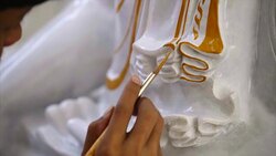 myanmar painter painting on buddha marble stone sculpture, close up shot Stock Footage