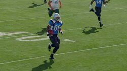 WS SLO MO. Running back sprints past defensive line, carries football into end zone for touchdown, and celebrates with teammate in professional football game. Stock Footage