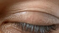 ECU Lid of a brown eye closing Stock Footage