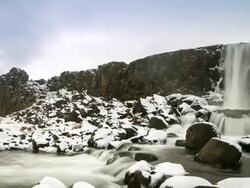 HD Time-lapse: Oxararfoss Waterfall winter Pingvellir National Park Iceland Stock Footage