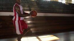 A basketball player dribbles past two defenders to slam dunk. Stock Footage