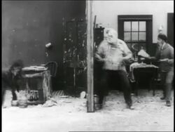 B/W 1916 3 men (1 is Charlie Chaplin) having pie fight on movie set / short Stock Footage