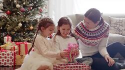 Mother watching daughters opening Christmas gift stuffed animals Stock Footage