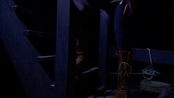 A sailor steps over another sailor sleeping below deck and rests on a stairway. Stock Footage