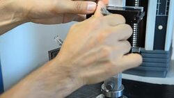 put a plastic film in a tensile machine Stock Footage