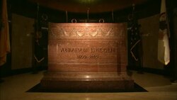 Marble sarcophagus bearing inscription Abraham Lincoln 1809-1865 surrounded by flags Stock Footage