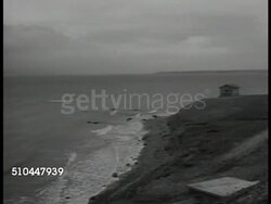 1947: TURKEY ARMY: HA VS Dardanelles Strait, city FG, BG. WS Shorefront, beach. HA VS Turkish infantry, soldiers marching in formation in parade. MS Turkish armored tank w/ soldier saluting from hatch top through parade, crowd BG. Instructional Video